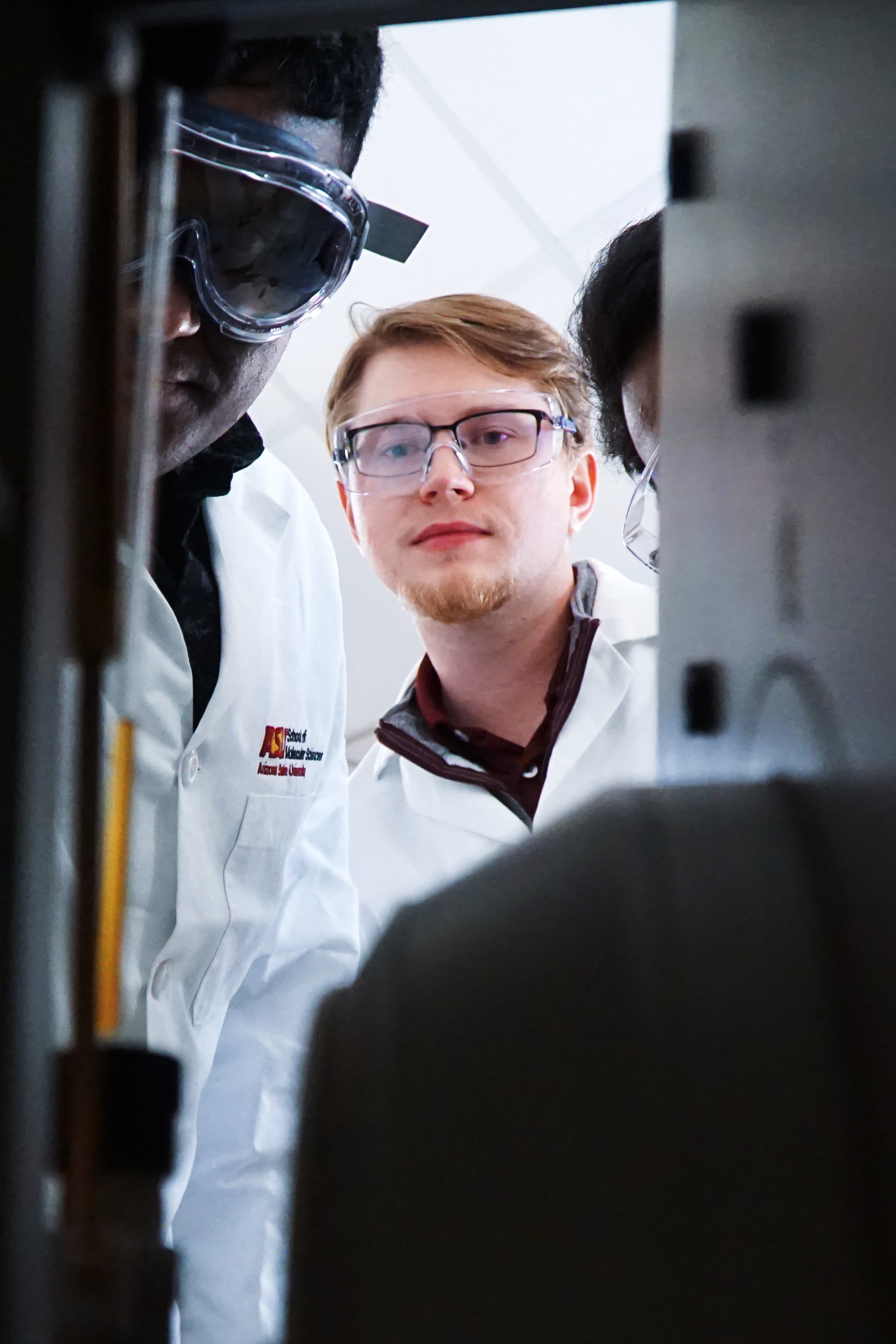 Researchers working with laboratory instrumentation in the Earley Lab